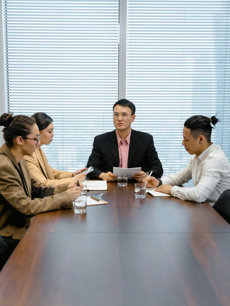 Team listening during a meeting while waiting for clear direction from leadership